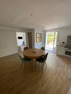 a living room with a wooden table and chairs at Calenzana GR20 in Calenzana