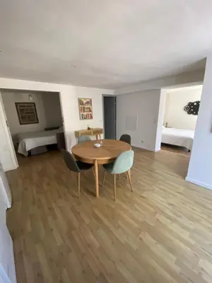 a dining room with a table and chairs and a bedroom at Calenzana GR20 in Calenzana