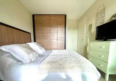 a bedroom with a bed and a dresser with a television at Appartement Résidence Salin Bay in Porto-Vecchio