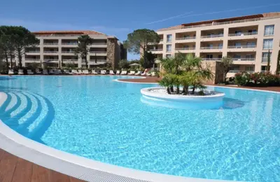 a large swimming pool in front of a building at Appartement Résidence Salin Bay in Porto-Vecchio