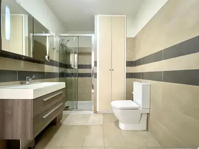a bathroom with a toilet and a sink and a shower at Appartement Résidence Salin Bay in Porto-Vecchio