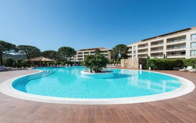 a large swimming pool in front of a building at Appartement Résidence Salin Bay in Porto-Vecchio
