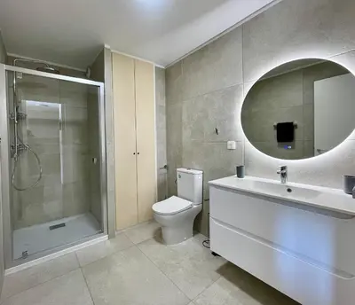 a bathroom with a toilet and a sink and a mirror at Appartement Résidence Salin Bay in Porto-Vecchio