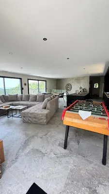 a living room with a couch and a foosball table at A CASA DI GHJULIA PISCINE CHAUFFEE PROCHE St FLORENT in Vallecalle