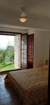 a bedroom with a bed and a large window at Le repaire des pirates in Pietrosella