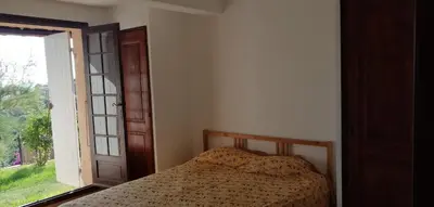 a bedroom with a bed next to a window at Le repaire des pirates in Pietrosella