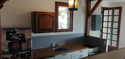 a kitchen with a sink and a window at Le repaire des pirates in Pietrosella