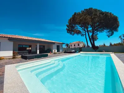 a swimming pool in front of a house at Capella Suttana in Ventiseri