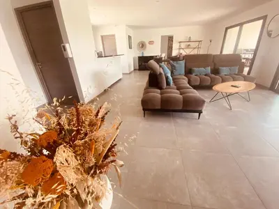 a large living room with couches and a table at Capella Suttana in Ventiseri