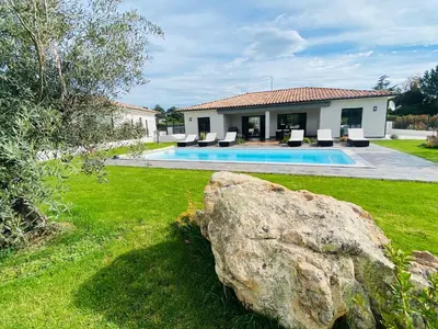 a house with a swimming pool and a large rock at Capella Suttana in Ventiseri