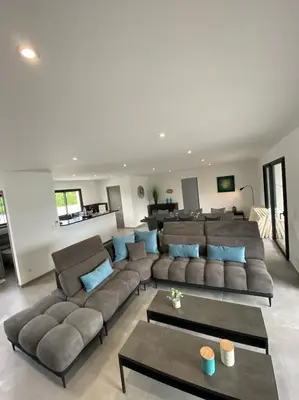 a large living room with a large couch and blue pillows at Capella Suttana in Ventiseri