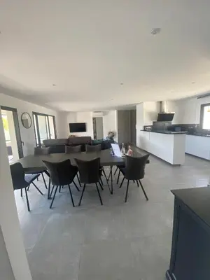 a dining room and kitchen with a table and chairs at Capella Suttana in Ventiseri