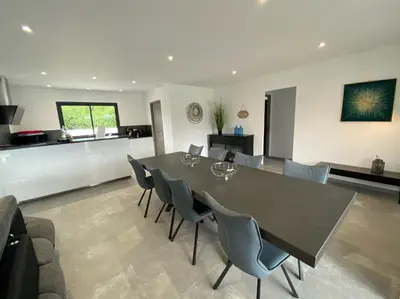 a dining room and kitchen with a table and chairs at Capella Suttana in Ventiseri
