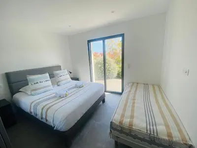 a bedroom with two beds and a window at Capella Suttana in Ventiseri