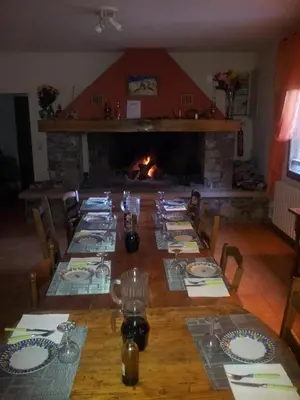 a dining room with a long table and a fireplace at Chambre d'Hôte 