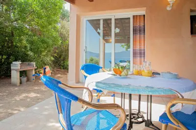 a blue table and chairs on a patio at Résidence Cantu di Mare in Olmeto