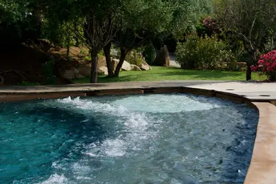 a pool with water shooting out of it at Résidence Cantu di Mare in Olmeto