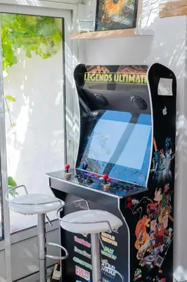 a video game arcade with two stools in front of it at CASA MONICA CARGESE - Roseroom - Chambre d hote in Cargèse