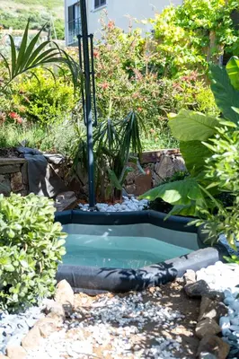 a small pool with a fountain in a garden at CASA MONICA CARGESE - Roseroom - Chambre d hote in Cargèse