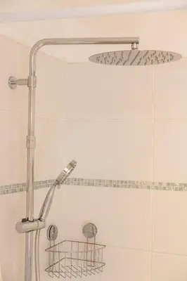 a shower with a shower head in a bathroom at CASA MONICA CARGESE - Roseroom - Chambre d hote in Cargèse