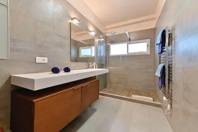 a bathroom with a sink and a shower at Appartement vue mer aux sanguinaires - stationnement et ascenseur in Ajaccio
