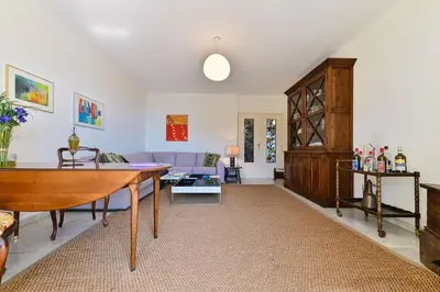 a living room with a table and a couch at Appartement vue mer aux sanguinaires - stationnement et ascenseur in Ajaccio