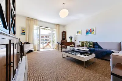 a living room with a couch and a table at Appartement vue mer aux sanguinaires - stationnement et ascenseur in Ajaccio