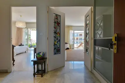 a living room with a door with stained glass at Appartement vue mer aux sanguinaires - stationnement et ascenseur in Ajaccio