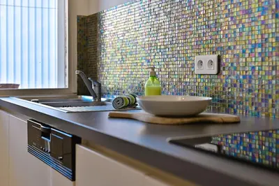 a kitchen with a sink and a bowl on a counter at Appartement vue mer aux sanguinaires - stationnement et ascenseur in Ajaccio