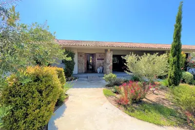 a house with a pathway leading to the front yard at Villa Pignotulli Di Cirendinu in Sainte-Lucie de Porto-Vecchio