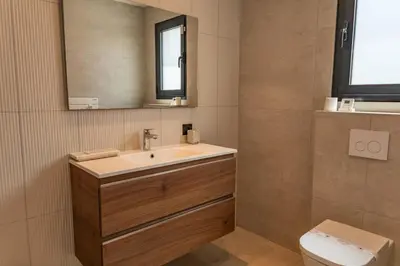 a bathroom with a sink and a toilet at Villa Caipirinha Di Arasu in Sainte-Lucie de Porto-Vecchio