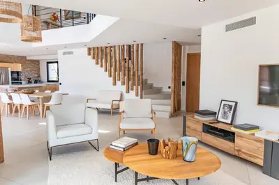 a living room with a table and chairs at Villa Caipirinha Di Arasu in Sainte-Lucie de Porto-Vecchio