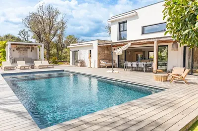 a house with a swimming pool and a deck at Villa Caipirinha Di Arasu in Sainte-Lucie de Porto-Vecchio