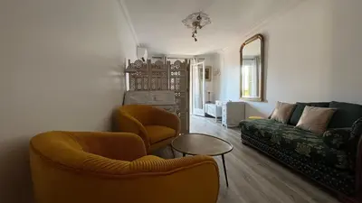 a living room with two chairs and a couch at LA CASA GIL in Ajaccio