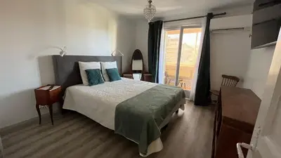 a bedroom with a bed and a window at LA CASA GIL in Ajaccio