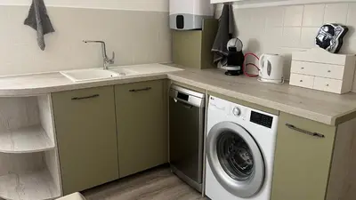 a kitchen with a washing machine and a sink at LA CASA GIL in Ajaccio