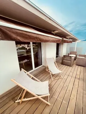 two chairs and a table on a deck at Grand studio toit terrase Ajaccio in Ajaccio