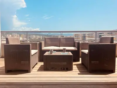 a patio with chairs and a table on a balcony at Grand studio toit terrase Ajaccio in Ajaccio
