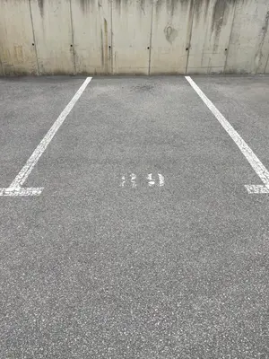 an empty parking lot with three bikes on it at Grand studio toit terrase Ajaccio in Ajaccio