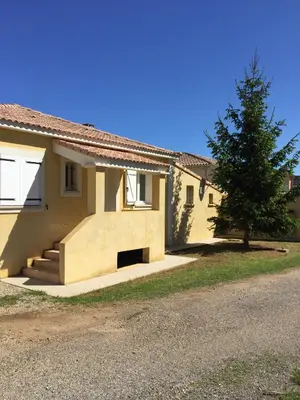 a house with a tree in front of it at Résidence MARI in Folelli