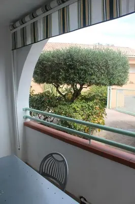 a view of a window with a table and a tree at Grazioso bilocale a 200 m dal mare in residence con piscina e WI-FI in Linguizzetta