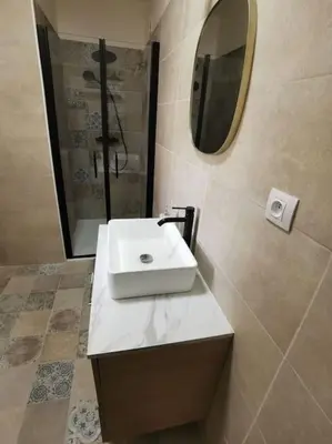 a bathroom with a white sink and a mirror at Appartement 2 ou 4 personnes. Venaco in Venaco