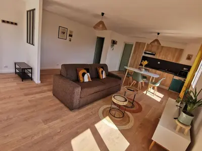 a living room with a couch and a table at Appartement 2 ou 4 personnes. Venaco in Venaco