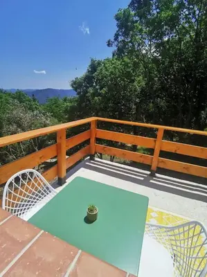 a blue table and chairs on a wooden fence at Appartement 2 ou 4 personnes. Venaco in Venaco