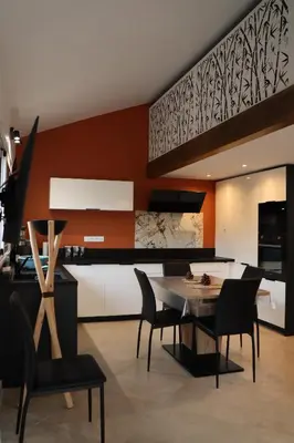 a kitchen and dining room with a table and chairs at maison climatisée 150 m de la mer in Santa-Maria-Poggio