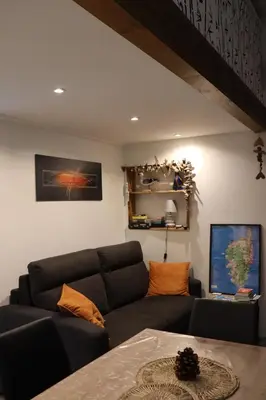 a living room with a couch and a table at maison climatisée 150 m de la mer in Santa-Maria-Poggio