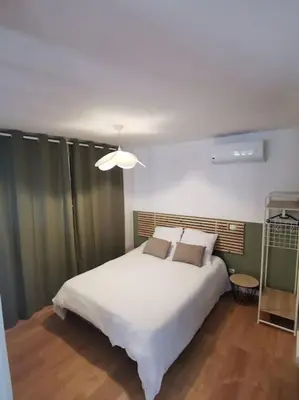 a bedroom with a large white bed in it at Appartement de 30m2 pour 2 personnes Venaco in Venaco