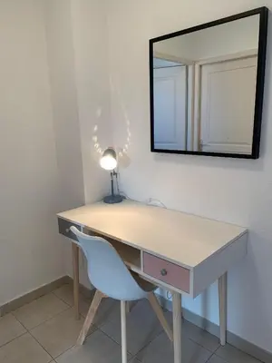 a desk with a chair and a mirror on a wall at Villa avec terrasse et vue piscine, proche plage in Moriani Plage