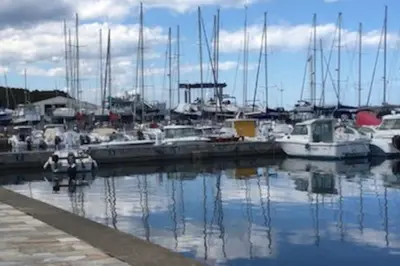 a group of boats docked in a harbor at Villa avec terrasse et vue piscine, proche plage in Moriani Plage