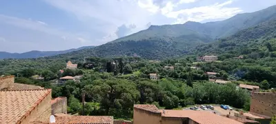 a view of a village with mountains in the background at The Charming House in Ville-di-Paraso